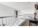 Upstairs hallway showcasing white railings, neutral walls, and decorative accents at 133 Heritage Ave, Castle Rock, CO 80104