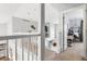 Bright hallway showcasing white railings, neutral walls, and an inviting doorway to a bedroom with a hanging chair at 133 Heritage Ave, Castle Rock, CO 80104