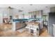 Open kitchen featuring gray cabinetry, a center island with seating, and stainless steel appliances at 133 Heritage Ave, Castle Rock, CO 80104