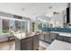 Bright and airy kitchen with a large island, stainless steel sink, and expansive backyard views at 133 Heritage Ave, Castle Rock, CO 80104