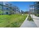 Spacious backyard area with a grassy lawn and mature landscaping near the building at 2550 Lawrence St # 106, Denver, CO 80205