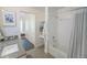 Bright bathroom with subway-tiled shower over tub and a view into a bedroom at 2550 Lawrence St # 106, Denver, CO 80205