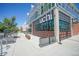 Commercial building with expansive glass windows showcasing lush greenery and a sidewalk at 2550 Lawrence St # 106, Denver, CO 80205