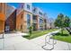 Contemporary townhome boasts brick accents, a manicured lawn, and convenient sidewalk access, exuding urban charm at 2550 Lawrence St # 106, Denver, CO 80205