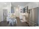 Bright kitchen with stainless steel refrigerator, counter seating, and white cabinets, offering a clean and functional design at 2550 Lawrence St # 106, Denver, CO 80205