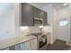 Modern kitchen featuring stainless steel appliances, gray cabinets, and stylish fixtures for a contemporary cooking experience at 2550 Lawrence St # 106, Denver, CO 80205