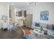 Open-concept living space features modern decor, stainless steel appliances, and hardwood floors, creating a chic and inviting atmosphere at 2550 Lawrence St # 106, Denver, CO 80205