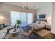 Bedroom with a sitting area, large window, and a modern bed, perfect for relaxation and enjoying natural light at 2550 Lawrence St # 106, Denver, CO 80205