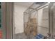 Storage cage provides secure space for belongings in neutral tones with white walls and neutral grey carpet at 2550 Lawrence St # 106, Denver, CO 80205