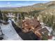 Aerial view of home with long driveway surrounded by mountain landscape at 6169 Flat Creek Dr, Evergreen, CO 80439