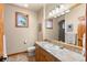 Bathroom featuring a wood framed window, natural wood trim, and tile countertops at 6169 Flat Creek Dr, Evergreen, CO 80439