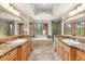 Luxurious bathroom with dual vanities, a soaking tub, and a separate shower at 6169 Flat Creek Dr, Evergreen, CO 80439