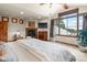 Large bedroom featuring scenic views, a fireplace, and a ceiling fan at 6169 Flat Creek Dr, Evergreen, CO 80439