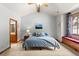 Cozy bedroom with a high ceiling, window seat, and an attached bathroom at 6169 Flat Creek Dr, Evergreen, CO 80439
