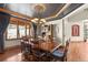 An elegant dining room with a classic wooden table, chairs, and a decorative chandelier at 6169 Flat Creek Dr, Evergreen, CO 80439