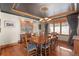 Charming dining room featuring hardwood floors, ample natural light, and a stylish chandelier fixture at 6169 Flat Creek Dr, Evergreen, CO 80439