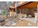 Exterior stone porch with seating and beautiful landscaping at 6169 Flat Creek Dr, Evergreen, CO 80439