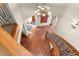 A grand foyer features hardwood floors, an elegant chandelier, and a winding staircase at 6169 Flat Creek Dr, Evergreen, CO 80439