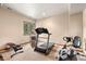 Home gym with carpet flooring featuring a treadmill, exercise bike, and weight bench at 6169 Flat Creek Dr, Evergreen, CO 80439
