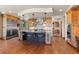 A spacious kitchen with stainless steel appliances, granite counters, and island seating illuminated by pendant lights at 6169 Flat Creek Dr, Evergreen, CO 80439