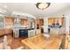 Spacious kitchen with granite countertops, custom wood cabinets, stainless steel appliances, and adjacent wooden dining table at 6169 Flat Creek Dr, Evergreen, CO 80439