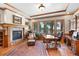 An inviting home office with a fireplace, a large window view, and custom wood finishes for a professional workspace at 6169 Flat Creek Dr, Evergreen, CO 80439