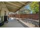 Covered deck with wooden support beams overlooking a fenced backyard, complete with a grill at 1641 Biscay Cir, Aurora, CO 80011