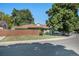 Charming home featuring a fenced yard, mature trees, and a well-maintained lawn in a desirable neighborhood at 1641 Biscay Cir, Aurora, CO 80011