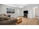Cozy living room featuring wood floors, a comfortable sofa, and a flatscreen television at 1641 Biscay Cir, Aurora, CO 80011