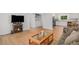 Bright living room with wood floors, a decorative fireplace, and a view into the kitchen and laundry room at 1641 Biscay Cir, Aurora, CO 80011