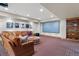 Finished basement showcasing a large screen, sectional sofa, and fun decor at 2411 S Milwaukee St, Denver, CO 80210