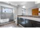 Modern bathroom with glass shower, sleek vanity, and neutral tiling at 2411 S Milwaukee St, Denver, CO 80210