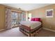 Inviting bedroom with access to balcony, floral curtains, and plush bedding at 2411 S Milwaukee St, Denver, CO 80210