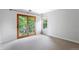 A bright, empty room with a private patio and carpet flooring at 2411 S Milwaukee St, Denver, CO 80210