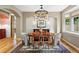 Elegant dining room with hardwood floors, arched doorways, designer chandelier, and large windows at 2411 S Milwaukee St, Denver, CO 80210