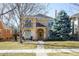 Charming stucco two-story home with a landscaped front yard and inviting front porch at 2411 S Milwaukee St, Denver, CO 80210