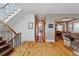 Spacious foyer with hardwood floors, staircase, and seamless flow to the dining room at 2411 S Milwaukee St, Denver, CO 80210