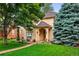 Charming home with a well-manicured front yard, beautiful trees, and a welcoming entrance at 2411 S Milwaukee St, Denver, CO 80210