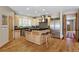 Modern kitchen featuring custom cabinetry, stainless steel appliances, a center island and hardwood floors at 2411 S Milwaukee St, Denver, CO 80210