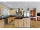 Bright kitchen featuring stainless steel appliances, stone countertops, a kitchen island and hardwood floors at 2411 S Milwaukee St, Denver, CO 80210