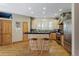 Well-lit kitchen with wooden cabinets, stainless steel appliances, large island, and hardwood floors at 2411 S Milwaukee St, Denver, CO 80210