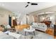 Open-concept living room with hardwood floors, staircase, and a dining area view at 2411 S Milwaukee St, Denver, CO 80210