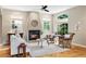 Well-lit living room showcasing hardwood floors, a fireplace, comfortable seating, and arched windows at 2411 S Milwaukee St, Denver, CO 80210