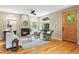 Bright living room with a fireplace, hardwood floors, comfortable seating, and large arched window at 2411 S Milwaukee St, Denver, CO 80210