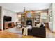 Comfortable living room with stone fireplace, hardwood floors, and built-in shelving and cabinets at 2411 S Milwaukee St, Denver, CO 80210