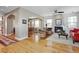 Bright living room boasts hardwood floors, a fireplace, and neutral paint, flowing into dining area at 2411 S Milwaukee St, Denver, CO 80210