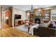 Relaxing living room featuring hardwood floors, a ceiling fan, a stone fireplace, and natural light at 2411 S Milwaukee St, Denver, CO 80210