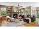 Cozy living room with hardwood floors, built-in shelves, a stone fireplace, and natural light at 2411 S Milwaukee St, Denver, CO 80210