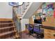 Home office nook under staircase with a modern computer and display of artwork at 2411 S Milwaukee St, Denver, CO 80210