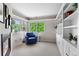 Bright office featuring large windows, carpet flooring, a fireplace and built-in cabinets at 2411 S Milwaukee St, Denver, CO 80210